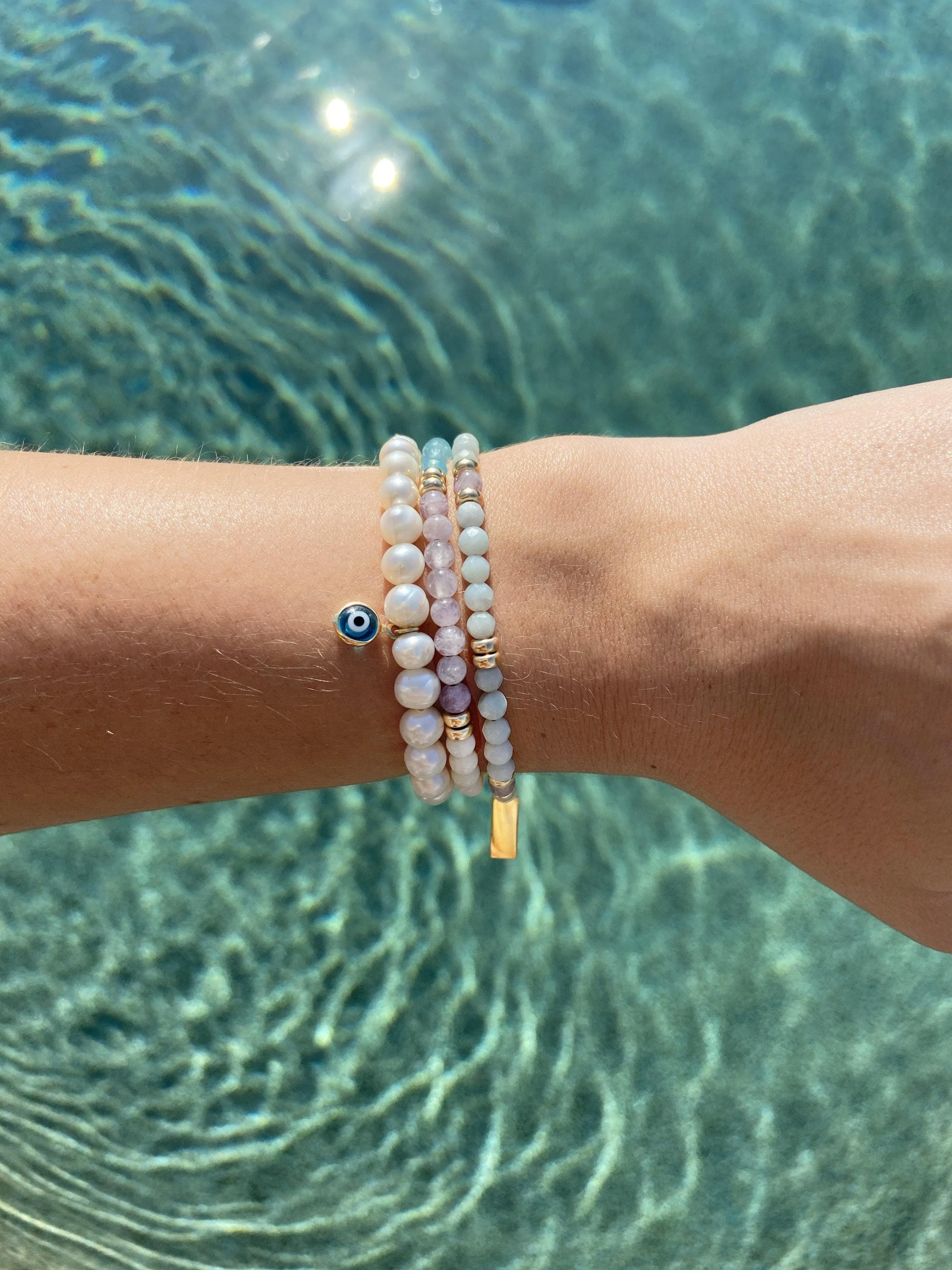 Wristband with White Pearls and Blue Evil Eye Charm